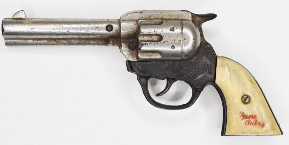 Kenton Gene Autry Cap Gun Pistol: Kenton Gene Autry cap gun pistol with white Gene Autry grips. Displays nicely with wear from play and age. The trigger works. Measures approximately 8 1/4" long.