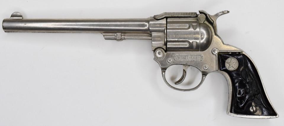 Hubley Wyatt Earp Cap Gun Pistol: Hubley Wyatt Earp cap gun pistol. Displays nicely with longhorn grips. The trigger works, but the barrel does not latch very well. Measures approximately 10 3/4" long.
