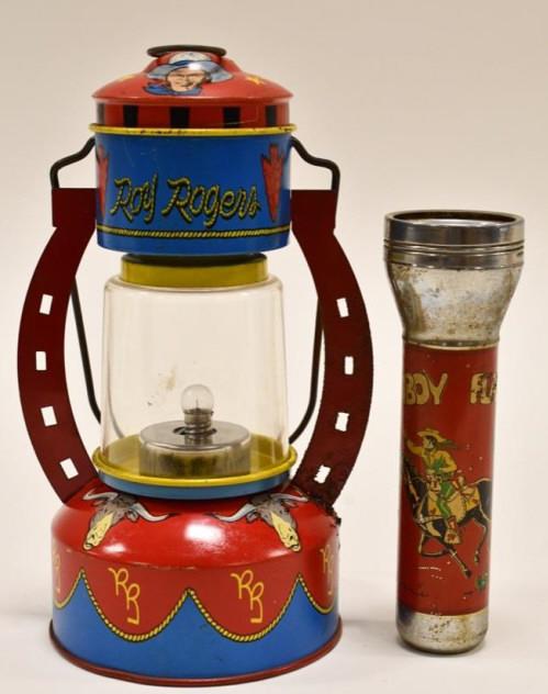 Ohio Art Roy Rogers Lantern and Cowboy Flashlight: Vintage Ohio Art Roy Rogers lantern and cowboy flashlight. Both display nicely with wear from use and age. Both are untested and have corrosion. Lantern measures approximately 8" tall.