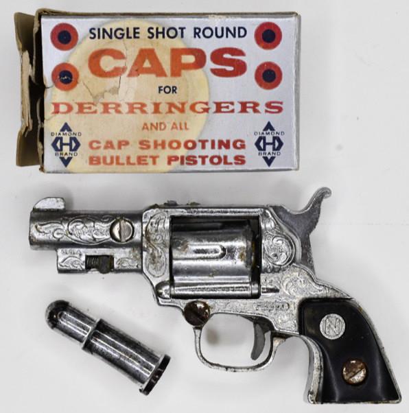 Nichols Derringers Cap Gun Pistol: Nichols Derringers cap gun pistol with single shot round caps. Displays nicely with wear from play and age. Measures approximately 3 1/4" long.