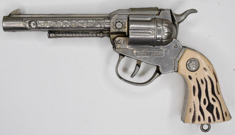 Actoy Wyatt Earp Cap Gun Pistol: Actoy Wyatt Earp cap gun pistol. Displays nicely with wear from use and age. The trigger works. Measures approximately 8 1/2" long.