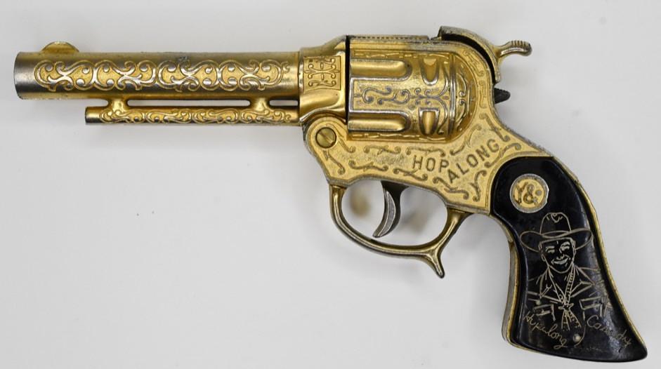 Wyandotte Hopalong Cassidy Gold Plated Cap Gun: Wyandotte Hopalong Cassidy gold plated cap gun. The trigger works. Displays nicely with wear from use and age. Measures approximately 8" long.