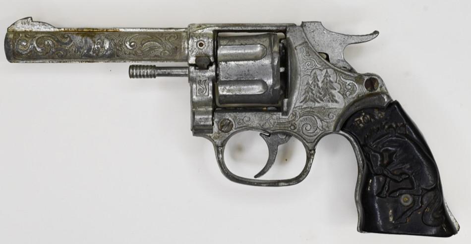 Kilgore Bronco Six Shooter Cap Gun Pistol: Kilgore Bronco six shooter revolving cap gun pistol. Displays nicely with wear from use and age. The one grip has a crack in it. The trigger works. Measures approximately 8" long.