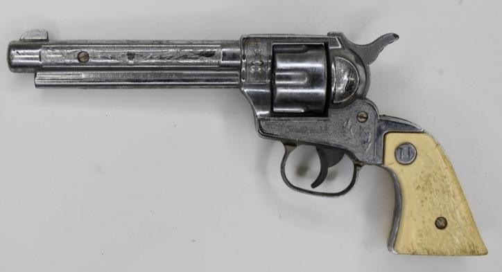 Nichols Stallion 38 Cap Gun Pistol: Nichols Stallion 38 cap gun pistol with revolving cylinder. Displays nicely with wear from use and age. The grip has a break in it. The trigger works. Measures approximately 9 1/2" long.