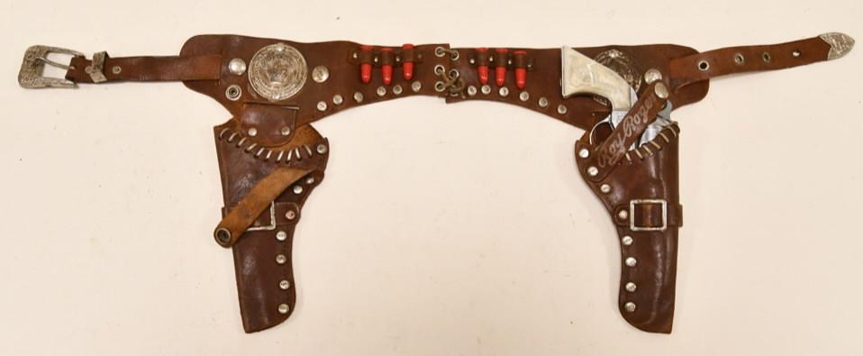 Kilgore Roy Rogers Cap Gun with Holster: Kilgore Roy Rogers cap gun with leather Roy Rogers holster. The cap gun has some corrosion and wear from use and age. The trigger works. The holster displays well with the bullets. Overall displays we