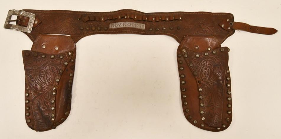 Roy Rogers Leather Holster for Cap Guns: Roy Rogers leather double holster for cap guns. Displays well with the Roy Rogers embossed on the belt. Some of the ammo holders are broke. Nice condition with wear from age and play.
