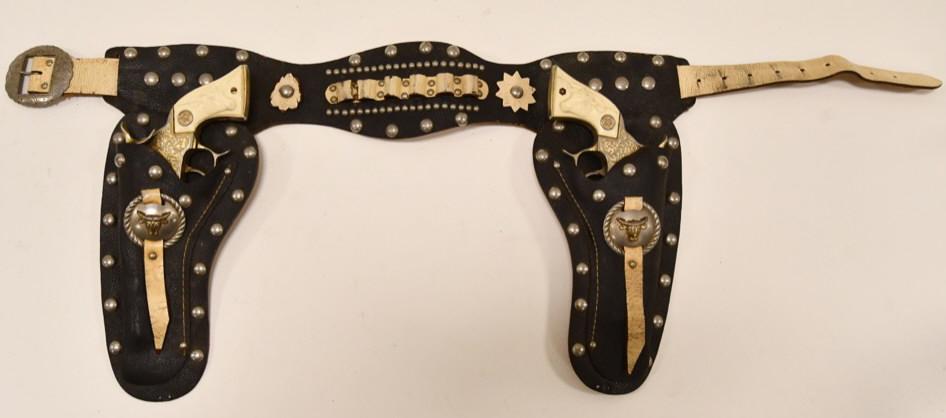 Hubley Gold Plated Texan Cap Gun Set w/ Holster: Outstanding Hubley gold plated Texan cap gun set with leather holster. The cap guns are in nice condition with some corrosion from age. Both of the triggers work. The one grip has a hairline crack on