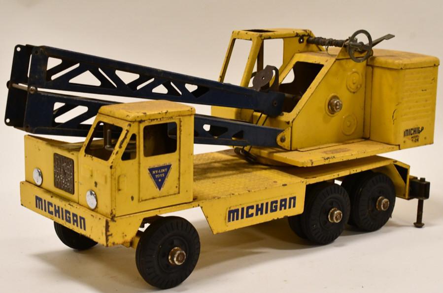Nylint Clark Michigan T-24 Crane Truck: Original Nylint Toys Clark Michigan crane truck model T-24. Has paint loss and wear from play and age. The string holding the boom needs restrung. Measures approximately 19" long