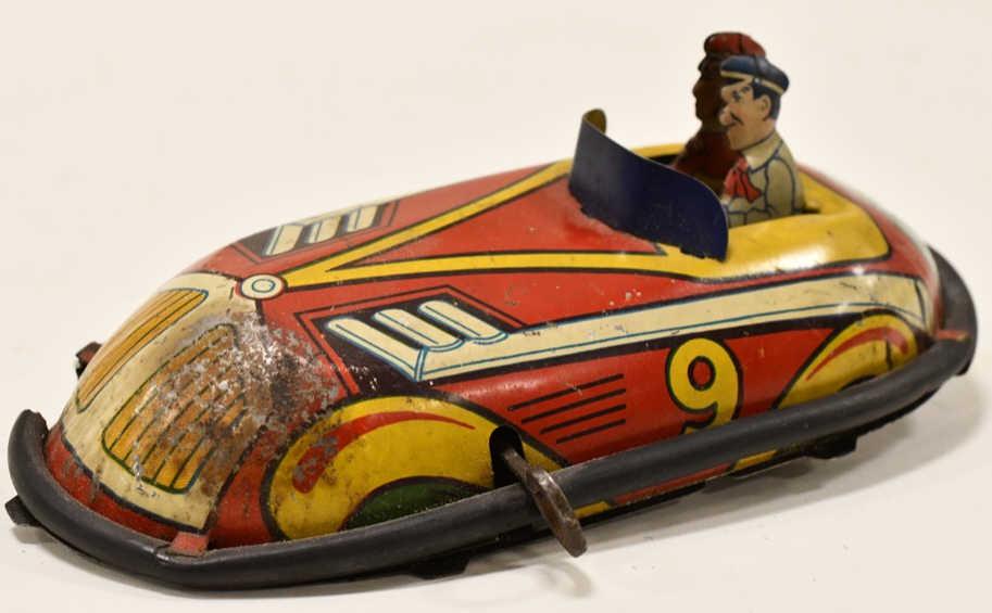 Lindstrom Tin Litho Windup 2 Person Bumper Car: Lindstrom tin litho windup 2 person bumper car. One of the wooden wheels brok off, the rubber bumper has cracking and missing pieces, and the windup does not work. Displays nicely with wear from play 