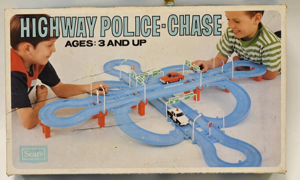 Sears Highway Police-Chase Battery Op. Set: Sears highway police-chase battery operated car set in the box. Nice condition with wear from play and age. Cars measures approximately 4" long.