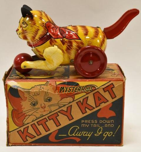 Louis Marx Tin Litho Mysterious Kitty Kat: Louis Marx tin litho mysterious kitty kat with the original box. When you press the tail the wheels spin. Displays nicely with light wear from play and age. Box has some wear and tear. Measures approx