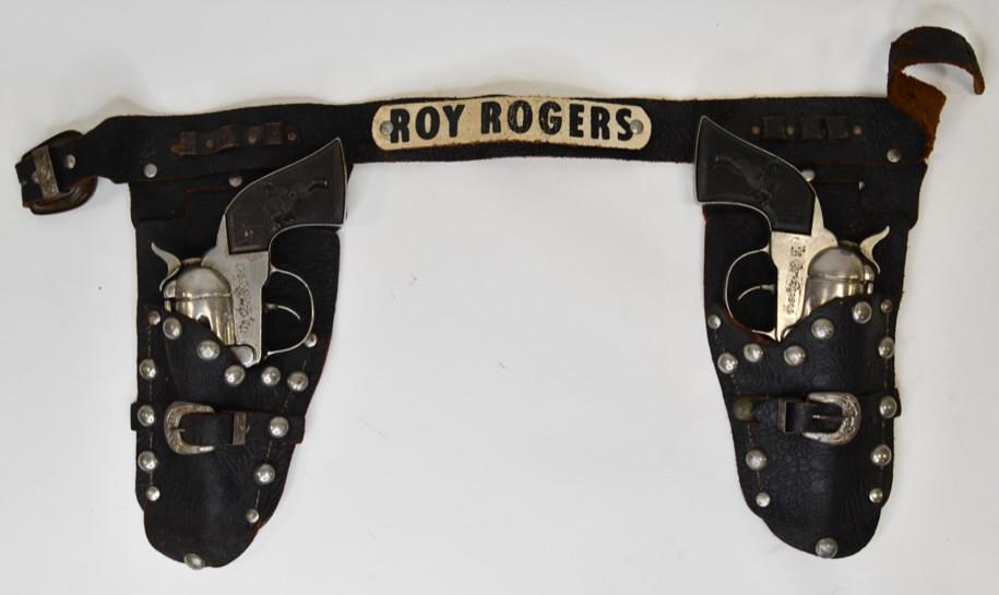 Classy Products Roy Rogers Cap Gun Set: Classy Products Roy Rogers cap gun set with matching Roy Rogers holster. The set displays nicely with wear from age and play. The triggers work, but they stick. Holster has some light wear considering