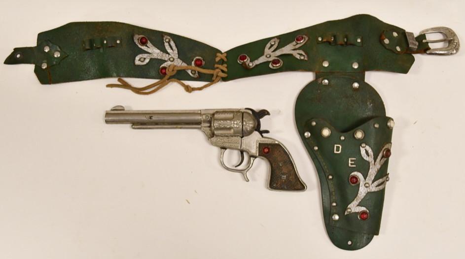 Geo. Schmidt Dale Evans Cap Gun with Holster: Geo. Schmidt Dale Evans cap gun with matching Dale Evans single holster. Cap gun displays nicely with jeweled grip. Displays nicely with wear from play and age. Gun measures approximately 9 1/2" long.