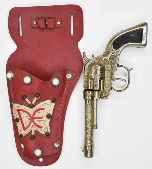 Buzz Henry Gold Dale Evans Cap Gun w/ Holster: Buzz Henry gold Dale Evans cap gun with matching Dale Evans single holster. Cap gun is in nice condition with wear to the gold finish. Displays nicely. Gun measures approximately 7 1/2" long.