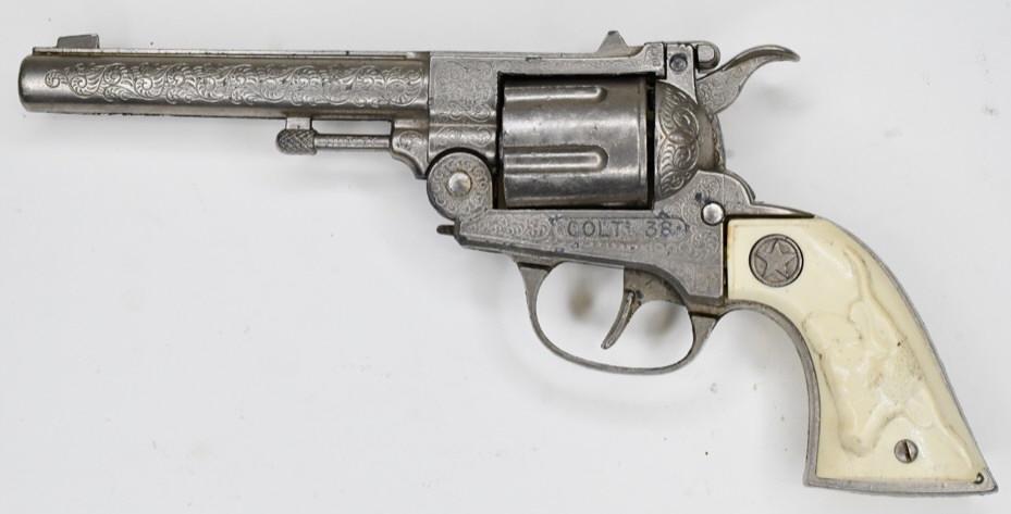 Hubley Colt 38 Cap Gun Pistol: Hubley Colt 38 cap gun pistol with revolving cylinder. Displays nicely with some wear from play and age. The trigger does not work. Gun measures approximately 10" long.