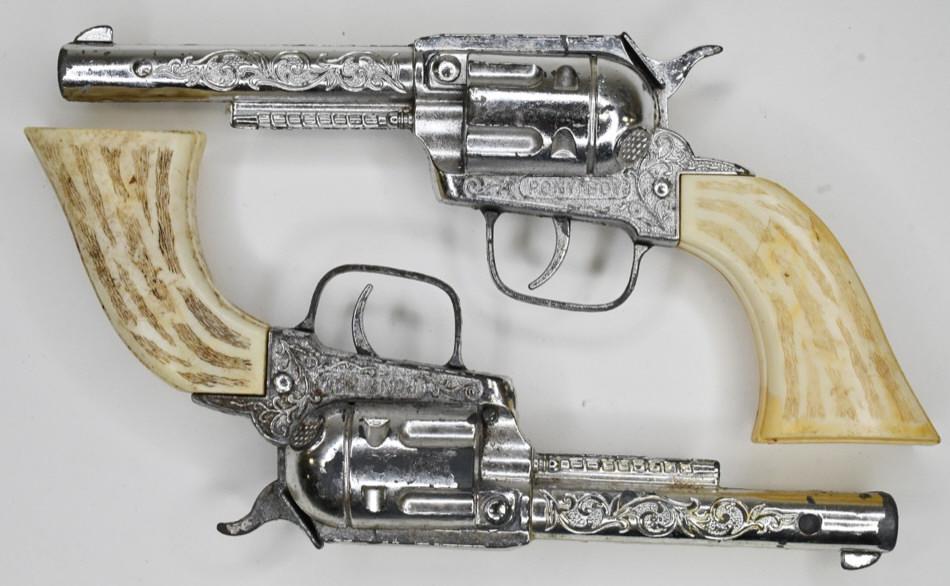 Pair of Hubley Pony Boy Cap Gun Pistols: Pair of Hubley Pony Boy cap gun pistols. Both have some wear from play and age. One trigger works, and the other one does not. Gun measures approximately 9" long.