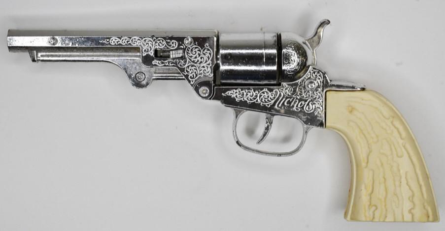 Nichols Cap Gun Pistol w/ Revolving Cylinder: Nichols cap gun pistol with revolving cylinder. Displays nicely with wear from play and age. The trigger works. Gun measures approximately 9" long.