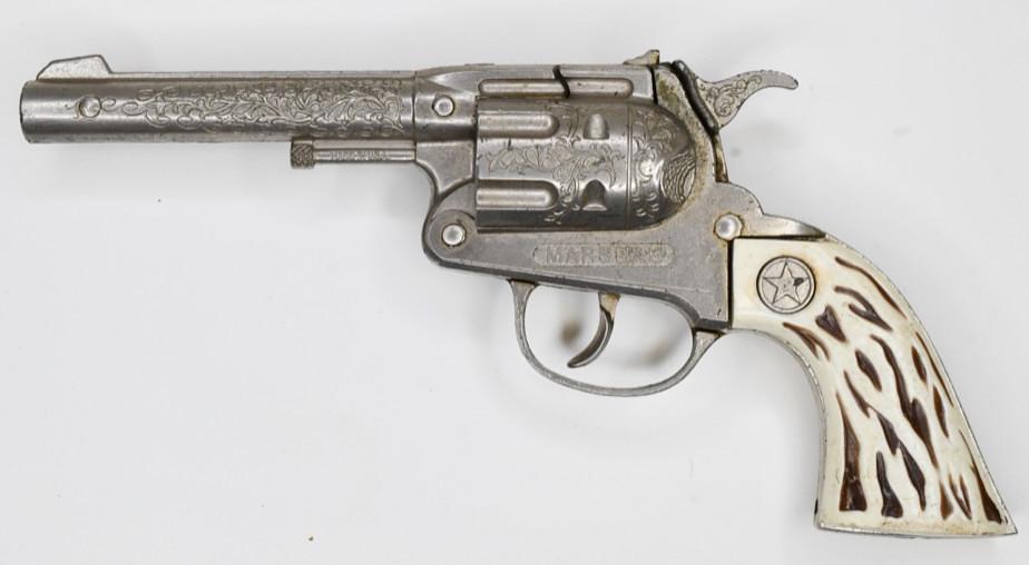 Hubley Marshal Cap Gun Pistol: Hubley Marshal cap gun pistol. Displays nicely with wear from play and age. The trigger works. Has a small chip on the bottom of the grip. Gun measures approximately 9 1/2" long.