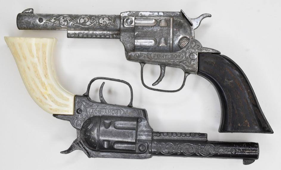 Pair of Hubley Pony Boy Cap Gun Pistols: Pair of Hubley Pony Boy cap gun pistols. Displays nicely with wear from age and play. The one triggr works, and the other does not. Gun measures approximately 9" long.