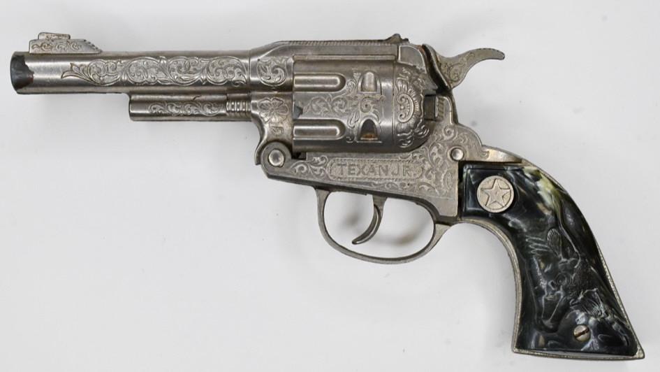 Hubley Texan Jr. Cap Gun Pistol: Hubley Texan Jr. cap gun pistols. Displays nicely with wear from play and age. The trigger works. Measures approximately 9 1/2" long.