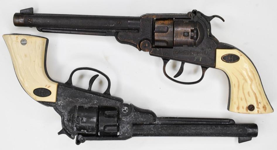 Pair of Halco Cap Guns w/ Revolving Cylinders: Pair of Halco cap gun pistols. The cap guns have some corrosion and wear from play and age. The hammer is broke on the one. Both triggers work. Each gun measures approximately 11" long.