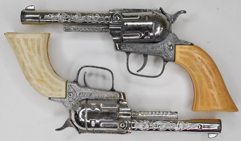Pair of Hubley Pony Boy Cap Gun Pistols: Pair of Hubley Pony Boy cap gun pistols. Both display nicely with wear from play and age. The triggers work, but both of them tend to stick. Each gun measures approximately 9 1/2" long.
