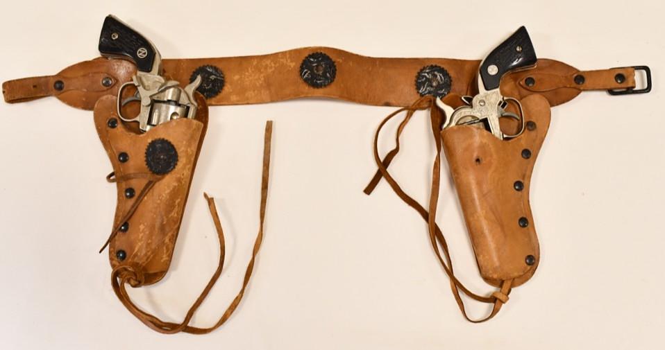 Nichols Stallion 32 Cap Gun Pistols with Holster: Nichols Stallion 32 cap gun pistols with genuine leather holster. Both display nicely with light wear from play and age. Both triggers work. THe holster is in nice condition with some wear to the leat