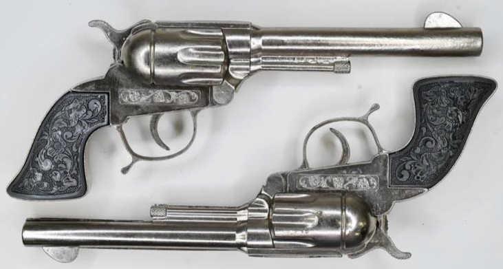 Pair of Leslie-Henry Cap Gun Pistols: Pair of Leslie-Henry cap gun pistols. The triggers work. Nice condition with some wear from play and age. Displays nicely. Gun measures approximately 10 1/2" long.
