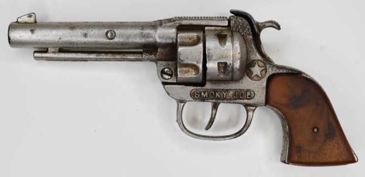 Hubley Smoky Joe Cast Iron Cap Gun Pistol: 1945 Smoky Joe cast iron cap gun pistol. The trigger works. Nice condition with some wear from play and age. Displays nicely. Gun measures approximately 8" long.