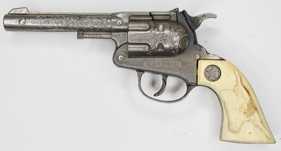 Hubley Marshal Cap Gun Pistol: Hubley Marshal cap gun pistol. Displays nicely with wear from play and age. The trigger works. Measures approximately 9 1/2" long.