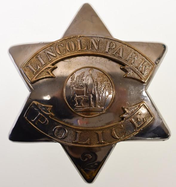 Obsolete Lincoln Park Police Pie Plate Badge No.2: Nice obsolete Lincoln Park Police "Pie Plate" badge no.2. Badge is in nice condition with wear. Has pinback. Back is marked "S.D. Childs Chicago" It measures approximately 3-1/2" tall by 3" across.