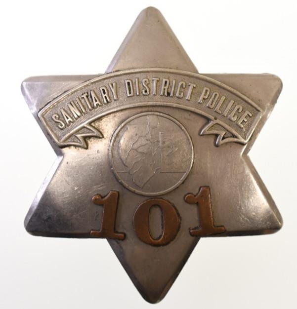 Illinois Sanitary District Police Pie Plate Badge: Nice early obsolete Illinois Sanitary Dristrict Police "Pie Plate" badge no.101 with copper numbers. Badge is in nice condition with wear from use and age. Has pinback. Back is unmarked. It measuresap
