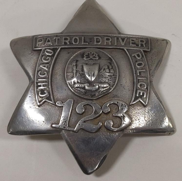 Obsolete Chicago Police Driver Pie Plate Badge: Obsolete Chicago Illinois Police Patrol Driver Pie Plate Badge no.123. Badge is in worn condition with new pinback added. Appears to have been heavily buffed and polished. Back is unmarked. It measure
