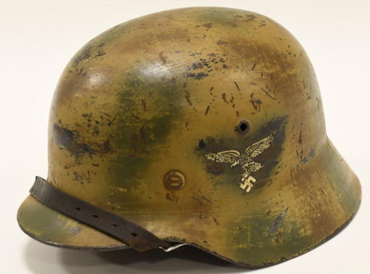 WWII German Luftwaffe Camouflage Helmet: Nice German Luftwaffe M40 Helmet with three color sprayed on camouflage pattern, sometimes called "Normandy Camo". The helmet is in good condition with period decals. Comes with liner and chin strap. 