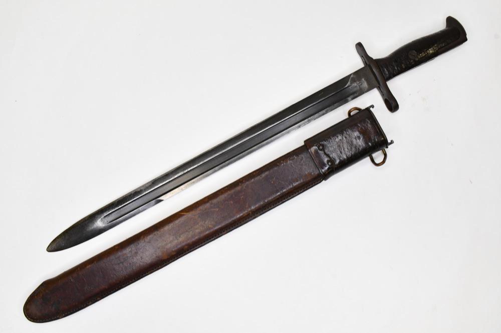 US Military M1905 RIA 1918 M1 Garand Bayonet: US military M1905 RIA 1918 M1 Garand bayonet with scabbard. Nice condition with wear from use and age. Displays well. Blade is marked "US RIA 1918". Overall measures approximately 21" across with scab
