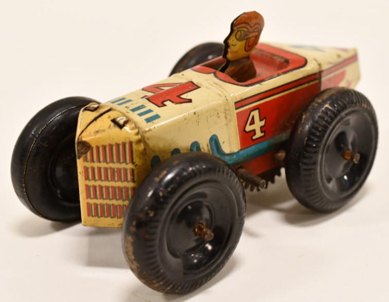 Marx Tin Litho Windup #4 Boat Tail Racer: Vintage Marx tin litho windup #4 boat tail racer in the harder to find red, white, and blue color. Displays nicely with paint loss and wear from age and play. Measures approximately 5" long.