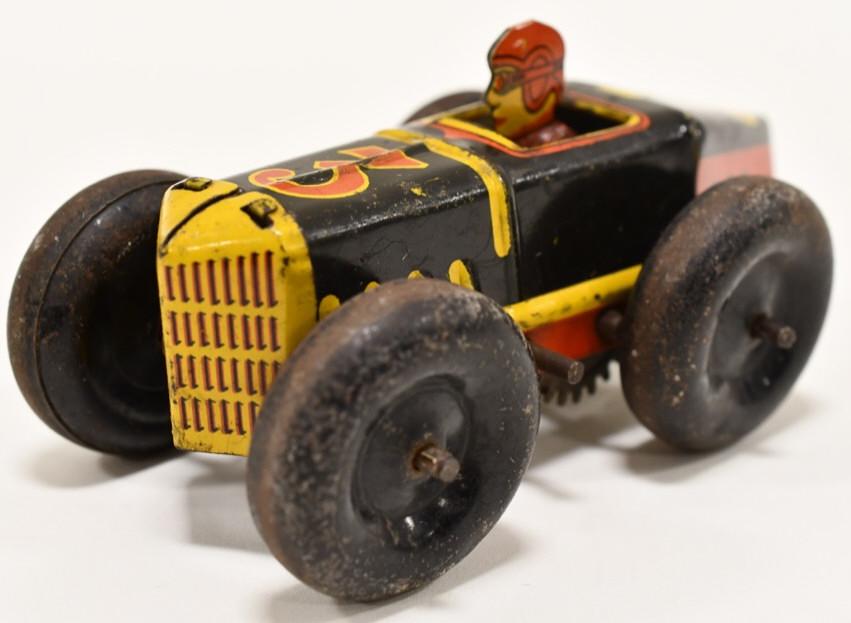 Marx Tin Litho Windup Boat Tail Racer #3: Marx tin litho windup #3 Boat Tail Racer. Car has paint loss and wear from age. Displays well with original man. Windup mechanism works. Measures approximately 5" long.