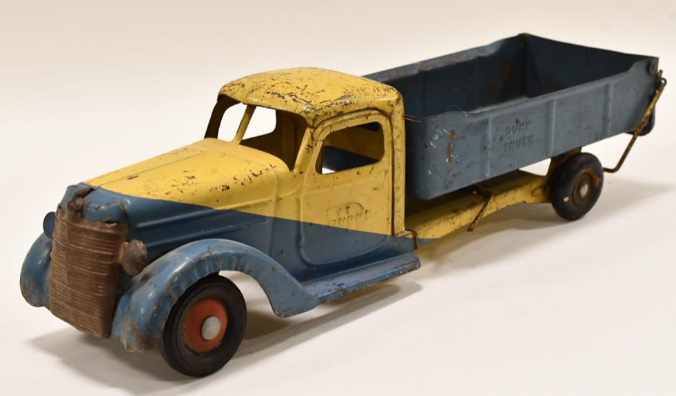 Original Buddy L International Dump Truck: Original Buddy L International dump truck. The cab appears to have some older paint touch ups. Displays nicely with paint loss and wear from play and age. Measures approximately 20 1/2" long.