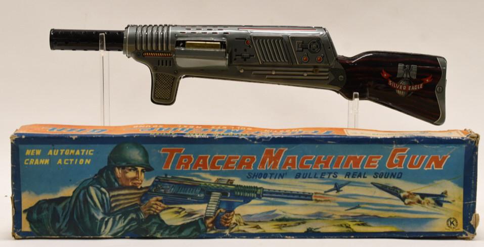 Japan Tin Tracer Crank Action Machine Gun: Japan tin litho Tracer crank action Silver Eagle machine gun with box. Comes with some ammunition. Displays nicely with light wear from play and age. Box has some wear and tear, but displays nicely wi