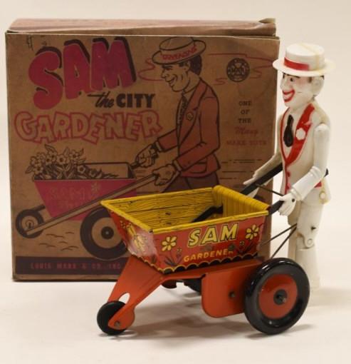 Marx Tin Windup Sam The City Gardener: Nice tin and plastic windup Sam the City Gardener with reproduction box. Displays nicely with some paint loss and wear from play and age. Windup mechanism works, but needs some help. Measures approxim