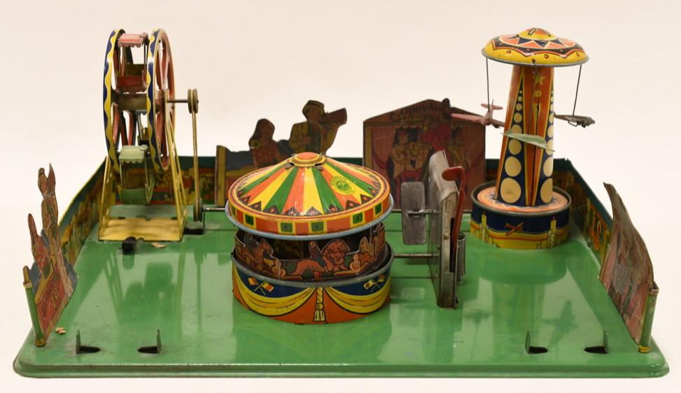 Wyandotte Tin Windup Circus Carnival Scene: Nice Wyandotte tin litho windup circus carnival scene. Displays nicely with some paint loss. Windup mechanism works for the carousel, but the others do not spin. MIssing some accessories / pieces. Mea