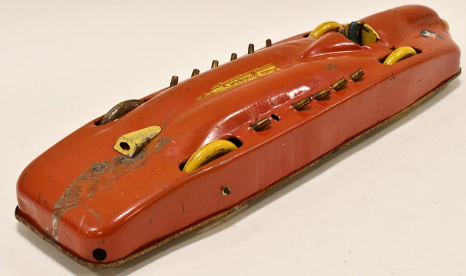 Buffalo Toys Red Streak Pull Wind Racer: Tin litho Buffalo Toys Red Streak pull wind racer. It is missing one of the pistons. Displays well with some paint loss and wear from play and age. The pull wind works. Measures approximately 21" long