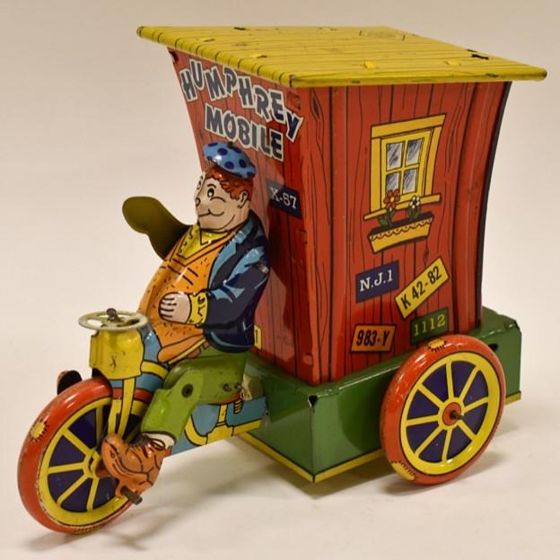 Wyandotte Tin Litho Windup Humphrey Mobile: 1950's Wyandotte tin litho wind up Humphrey Mobile. Very nice condition with light play wear. Windup mechanism works. Displays very well with great color and graphics. It is missing the little chimeny