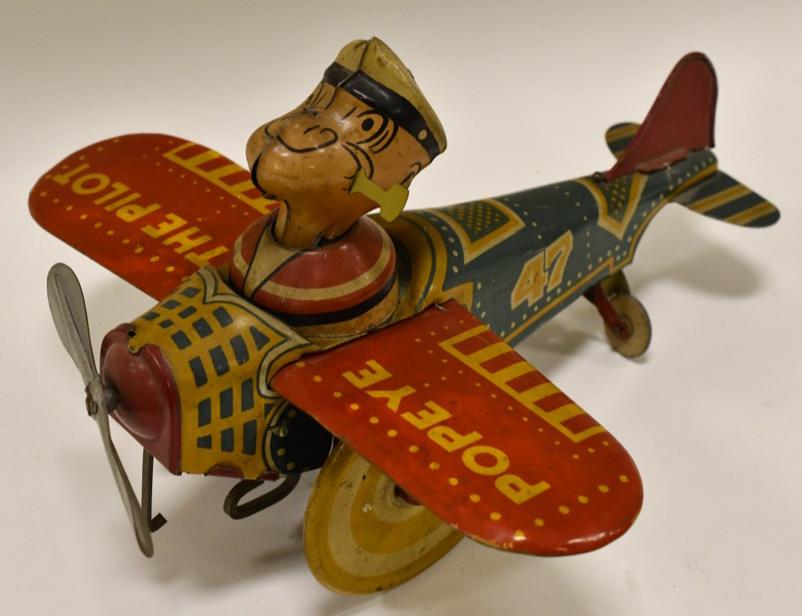 Marx Tin Litho Windup Popeye The Pilot Plane: Nice Marx tin litho Popeye The Pilot windup plane. Displays nicely with light paint loss and wear from play and age. Windup works. Measures approximately 9" long.