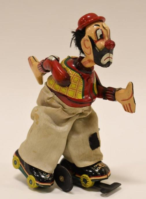 T.P.S. Tin Litho Clown On Roller Skates: T.P.S. tin litho wind up Clown On Roller Skates. The windup mechanism needs some work. Displays nicely with light wear from play and age. Measures approximately 6" tall.