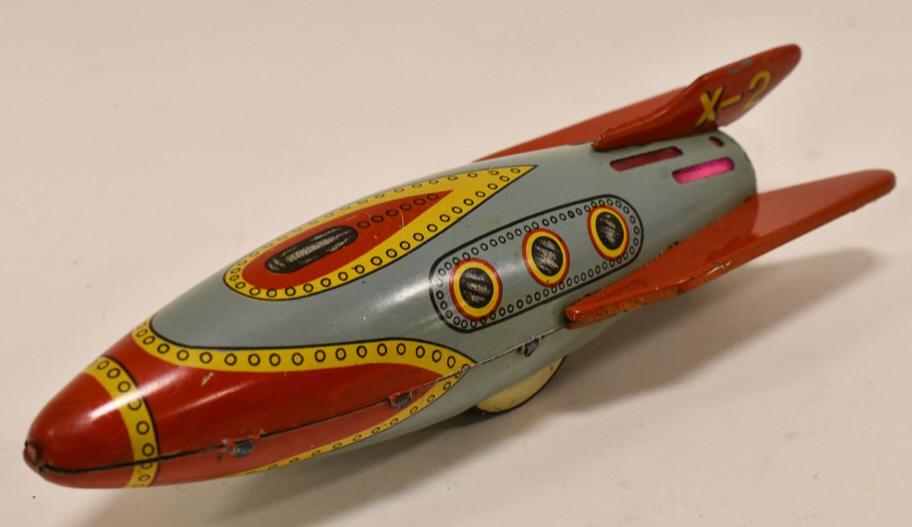 Modern Toys Tin Litho Friction X-2 Space Ship: Modern Toys tin litho friction X-2 spcae ship. Displays nicely with some scratches to the paint and wear from age. The friction works, but the flint needs to be replaced. Measures approximately 7 1/2"
