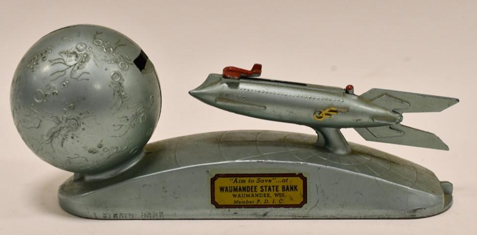 Strato XU-232 Rocket Ship Mechanical Coin Bank: Strato XU-232 rocket ship mechanical coin bank. Coin can be pulled back with the ship and can be shot at the moon. Nice working condition. Displays well with some light wear from age and play. Measure