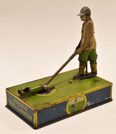 Strauss Tin Litho Mechanical Jocko The Golfer: Strauss tin litho mechanical Jocko The Golfer. The toy is pull string action. When the string is pulled the gulfer sways back and forth to hit the balls. Displays nicely with paint loss and fading fro