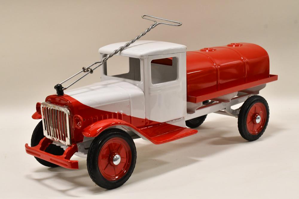 Restored Buddy L Sit N Ride Tanker Truck: Nice professionally restored Buddy L sit n ride International tanker truck. Displays well with nickel plated radiator guard, Buddy L Balloon tires, and red and white two tone paint job. Nice condition