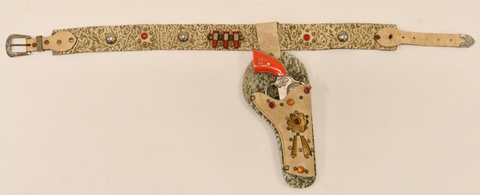 Kenton Gene Autry Cap Gun & Single Leather Holster: Kenton Gene Autry cap gun with single jeweled leather holster. The cap gun is in very nice condition with light wear from age. The holster is in nice condition with wear to the leather. Nice set that 